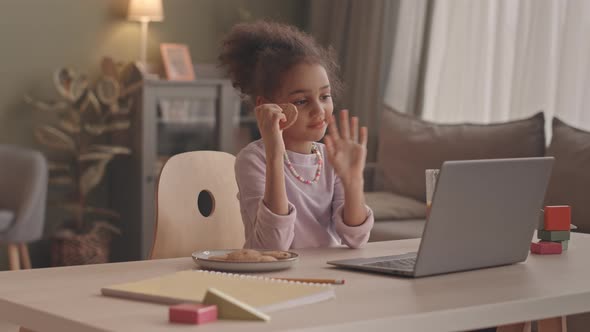 Little Girl Having Video Call on Laptop from Home alt