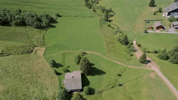 Aerial View of a Valley in Switzerland with Chalets and a Mountainous Landscape