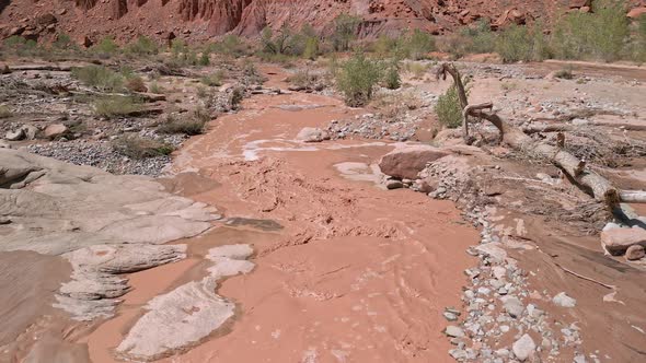 Flying over muddy flood waters through the Utah desert after rainstorm