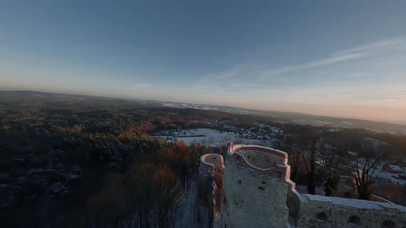 Aerial View of Beautiful Historic Castle Ruins on the Hill in Winter at Sunset