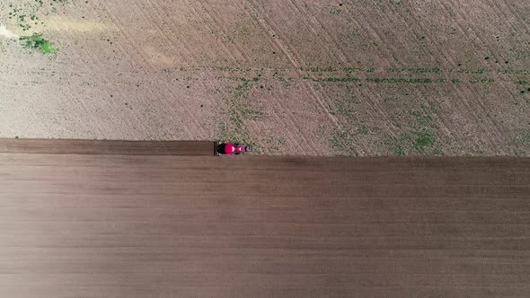 Aerial View Tractor Plows the Land, Processing the Field Before Sowing, Spring