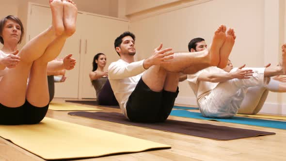 Group of people performing yoga