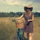 Tourist Girl Relaxing On Countryside Wildflower Field.Woman Cyclist Walking With Bike. - VideoHive Item for Sale