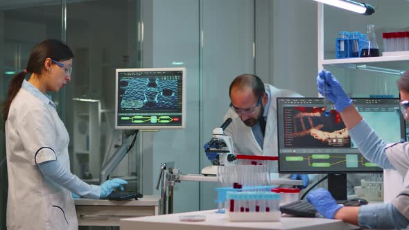 Man Research Scientist Looking at Samples Under Microscope