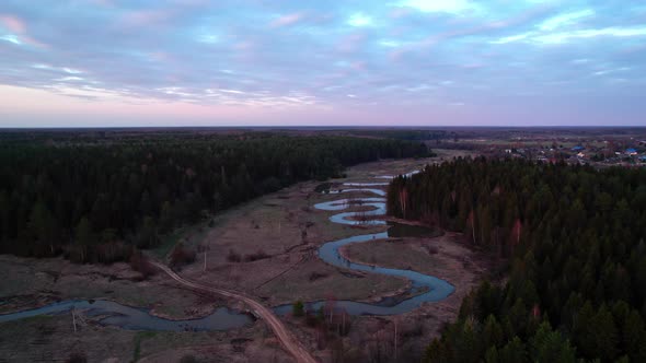 Aerial View From the Top of a Valley with a Winding River Forest and Village