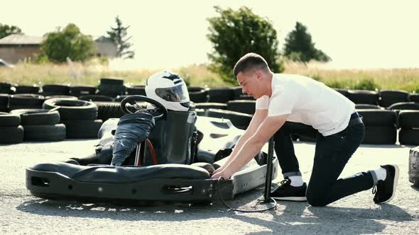 Attractive Man Sititng in a Gocart on the Track