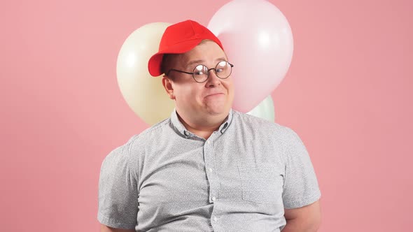 Funny Man with Air Balloons Isolated Over Pink