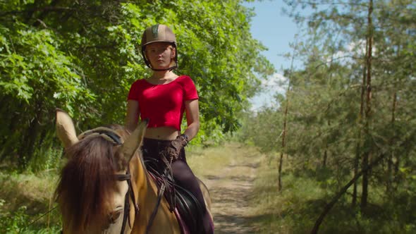 Serious Girl Rider in Helmet Riding on Horse