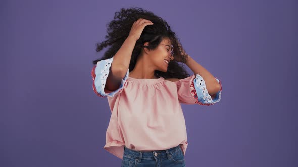 Ethnic Black Female in Sunglasses Colorful Blouse and Jeans