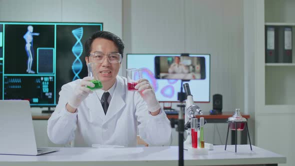 Asian Scientist Man Using Smartphone Recording Video While Researching In The Laboratory alt