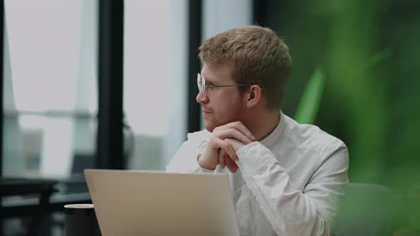 Focused Concentrated Young Businessman Sit at Desk Look at Laptop