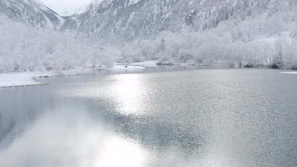 Beautiful Aerial Shot of Klammsee Reservoir with Snowy Mountains in Background