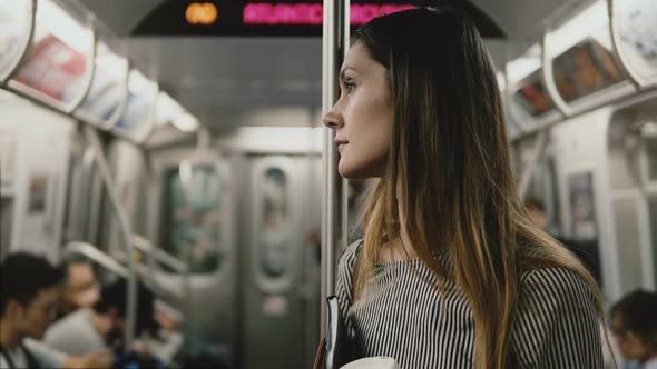 Serious Beautiful European Businesswoman Tired and Stressed on the Subway Train, Looking Around