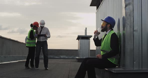 Man Engineer with a Beard and Safety Equipment at