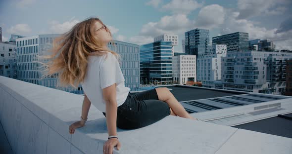 Chill Relaxed Woman on Rooftop of Big City