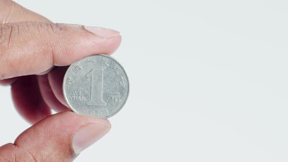Fingers Hold A Chinese 1 Yuan Coin Back 