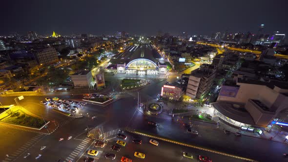 Aerial view of Hua Lamphong or Bangkok Railway Terminal Station at night with skyscraper buildings