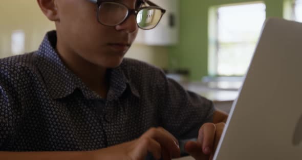 Boy using laptop in the class