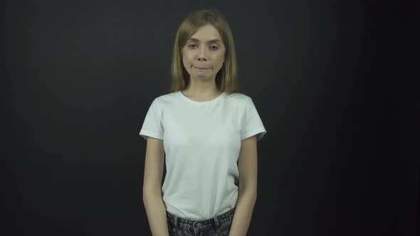 Girl with Fair Hair Pulls Faces Posing for Photo Shoot