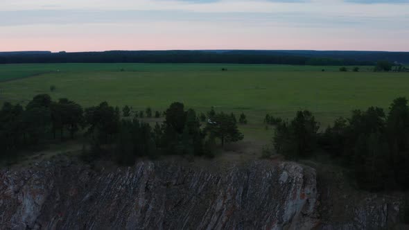 Aerial View of a Car on the Edge of a Cliff