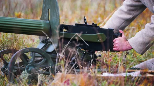 A Military Man Fixing the Position of a Machine Gun