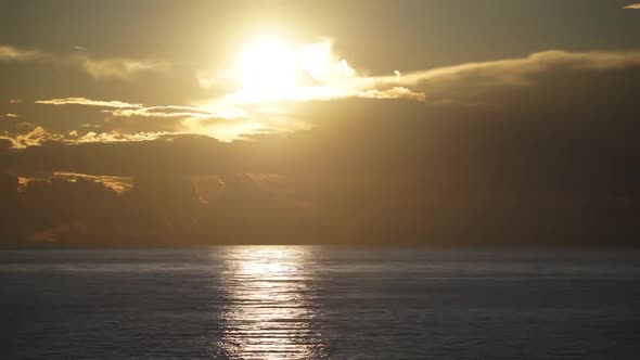 8K Amazing Sunset Colors From Behind the Clouds Over the Sea