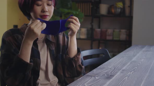 A Beautiful Lady is Putting a Protective Mask on Her Face