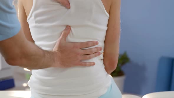 Female patient receiving back massage from physiotherapist