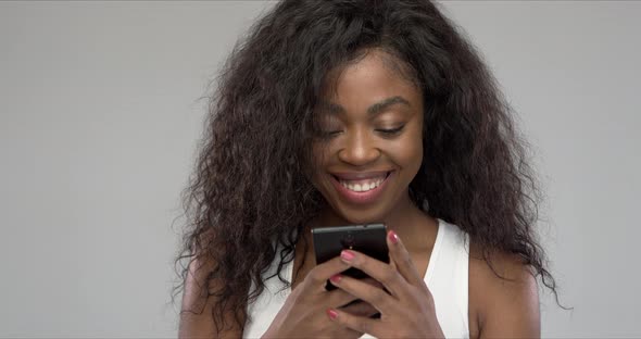 Happy African American Woman Using Smartphone