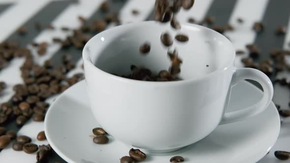 Aroma Roasted Coffee Beans Falling Into a Cup