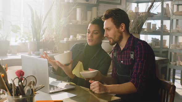 Woman and Man Discuss Design of Ceramic Items