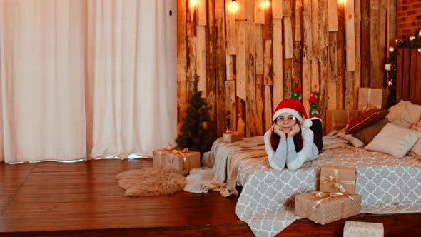 Woman Lying on Bed with Presents