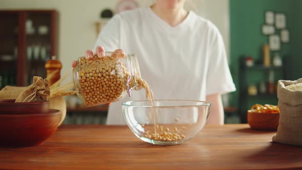 Grocery Putting Chickpeas in Bowl Closeup