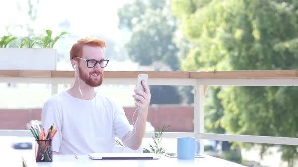 Online Video Chat on Smartphone, Sitting in Balcony of Office Outdoor