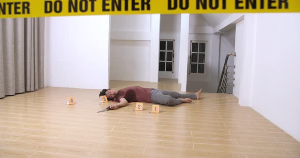 Dead Man Body And Knife In Blood Lying On Floor At Crime Scene