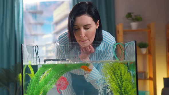 Pensive Young Woman at the Goldfish Aquarium