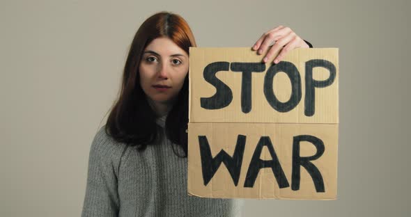 Ukrainian Girl Holding an Antiwar Placard in Her Hand