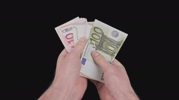 Male Hands Count a Lot of Euro Bills of Various Denominations with Alpha Channel