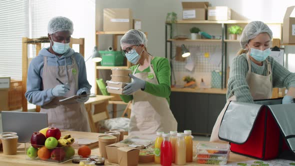 Multiethnic Team Working at Eco Food Delivery Service during Pandemic