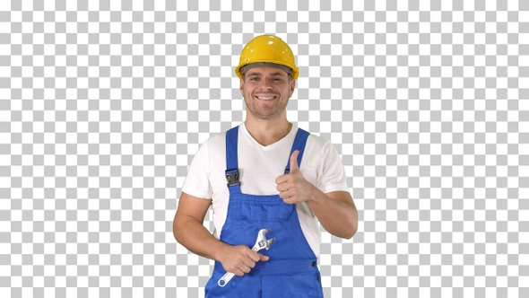 Worker with wrench showing thumb up and smiling to camera