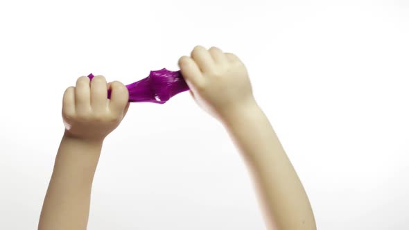 Child Hands Playing Oddly Purple Slime on White Background. Antistress