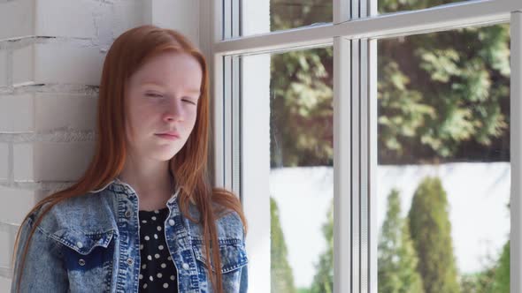 Bored Child with Sad Eyes By Window