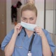 Female Doctor Putting on Mask at Home - VideoHive Item for Sale