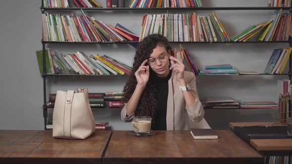 Woman With Coffee On Her Table Wear Her Eyeglasses Before Reading