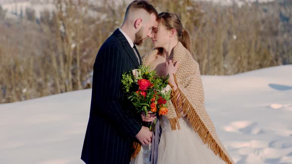 Couple on the Background of Snowcapped Mountains