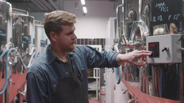 Brewery Worker Setting Parameters On Storage Tank