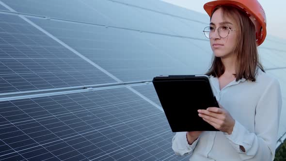 Inspector Engineer Woman Holding Digital Tablet Working in Solar Panels Power Farm