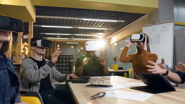 Focused Business Team Using VR Virtual Reality Glasses in the Modern Office