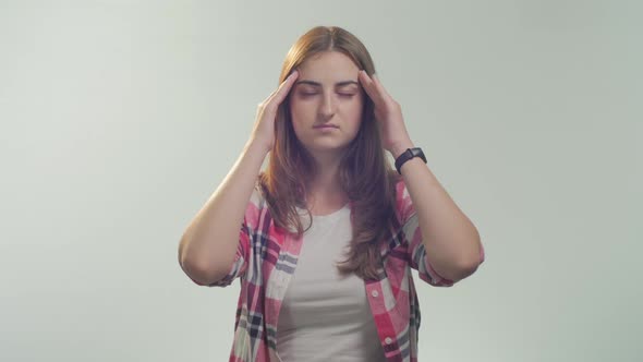 Young woman having head ache 