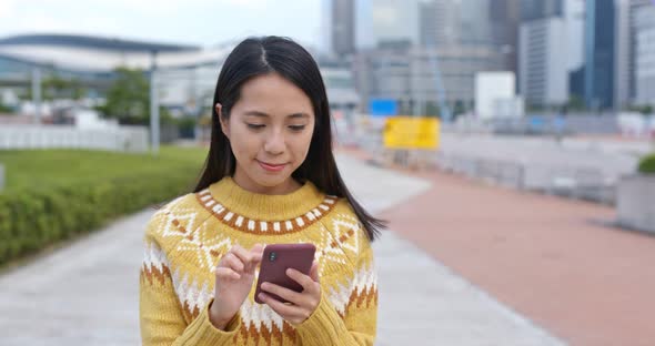 Woman use of smart phone in city